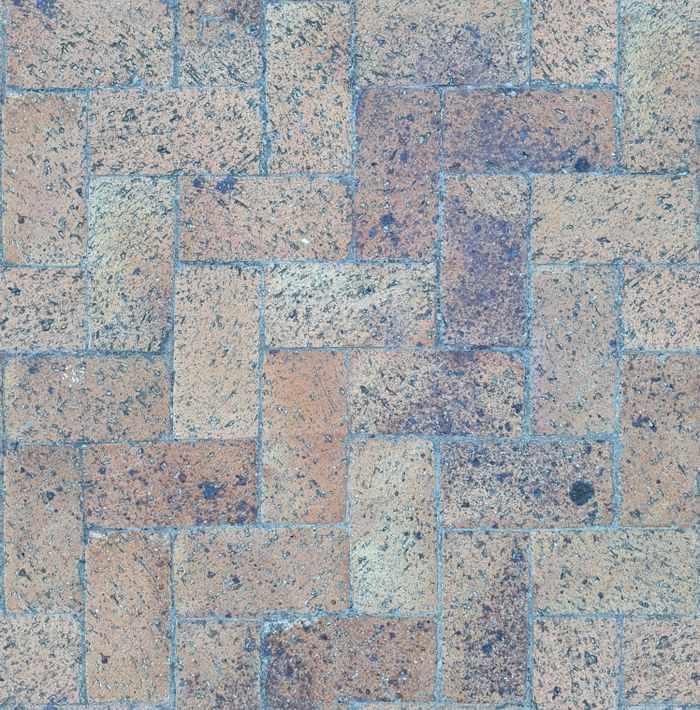 High-quality image of a herringbone patterned brick pavement captured from above.